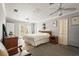 Spacious main bedroom with french doors, ceiling fan, neutral paint and carpet at 6640 Peacock Rd, Sarasota, FL 34242