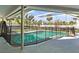 Inviting screened-in pool area with ample seating and a safety fence at 6640 Peacock Rd, Sarasota, FL 34242