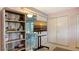 Bedroom with a large tv, shelves and a door to the exterior at 6716 Keystone Dr, Sarasota, FL 34231