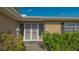 Inviting front entrance featuring decorative security doors, red ribbons, twin lanterns, and lush landscaping at 6716 Keystone Dr, Sarasota, FL 34231