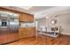 Open kitchen area featuring stainless steel appliances, wood cabinets, granite countertops, and an adjacent dining area at 6716 Keystone Dr, Sarasota, FL 34231