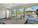 Bright sunroom with large windows, dining area, and a view of the gazebo in the landscaped backyard at 6716 Keystone Dr, Sarasota, FL 34231