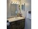 Bathroom vanity with decorative mirror and floral arrangement at 7109 Java Dr, Sarasota, FL 34241