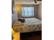 Well-lit bedroom featuring ceiling fan and large window with dresser at 7109 Java Dr, Sarasota, FL 34241