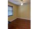 Simple bedroom featuring hardwood floors, a window with blinds, and neutral walls at 7109 Java Dr, Sarasota, FL 34241