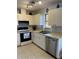 Clean kitchen featuring stainless steel appliances, white cabinets, and modern lighting at 7109 Java Dr, Sarasota, FL 34241