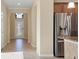 Bright foyer with tile flooring, decorative glass door, and view into other rooms at 7140 Marsh View Ter, Bradenton, FL 34212