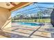 Covered pool area featuring a spa, tile floors, and view of the yard at 7140 Marsh View Ter, Bradenton, FL 34212