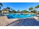 Beautiful community pool with lounge chairs, clear water, and tropical landscaping at 7140 Marsh View Ter, Bradenton, FL 34212