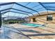 Enclosed pool area featuring a spa and tile floors, adjacent to the home at 7140 Marsh View Ter, Bradenton, FL 34212