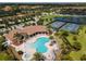 Aerial view of the community pool with lounge chairs and tropical landscaping in a beautiful neighborhood at 7140 Marsh View Ter, Bradenton, FL 34212