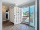 Inviting entryway with modern gray floors, white door, and sidelight offering a glimpse of the manicured front yard at 7225 Las Casas Dr, Sarasota, FL 34243