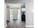 Clean, bright entryway with gray wood floors, white door, storage closet, and a glimpse of the office at 7225 Las Casas Dr, Sarasota, FL 34243