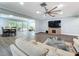 Living room area open to dining space with sliding glass door, neutral tones, and hardwood style flooring at 7225 Las Casas Dr, Sarasota, FL 34243