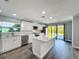 Bright kitchen featuring white cabinetry, stainless steel appliances, and a center island at 7225 Las Casas Dr, Sarasota, FL 34243