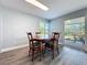 Bright dining room with a wooden table set and natural light streaming through the sliding glass doors at 7225 Las Casas Dr, Sarasota, FL 34243