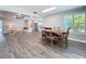 Open concept dining room featuring a wooden table, flowing into the living room and kitchen at 7225 Las Casas Dr, Sarasota, FL 34243