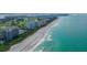 Panoramic aerial view of a coastal community with condos, beaches, and turquoise waters at 775 Longboat Club Rd # 406, Longboat Key, FL 34228