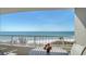 Oceanfront balcony view with outdoor seating at 775 Longboat Club Rd # 406, Longboat Key, FL 34228