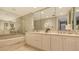 Elegant bathroom featuring marble accents, double sinks, and a soaking tub at 775 Longboat Club Rd # 406, Longboat Key, FL 34228