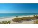 Scenic view of a sandy beach with clear waters, palm trees, and blue sky at 775 Longboat Club Rd # 406, Longboat Key, FL 34228