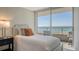 This bedroom features balcony access with ocean view at 775 Longboat Club Rd # 406, Longboat Key, FL 34228