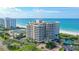 Upscale condo building featuring a pool, tennis court, and beach access at 775 Longboat Club Rd # 406, Longboat Key, FL 34228