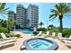 Pool and jacuzzi with the condo in the background at 775 Longboat Club Rd # 406, Longboat Key, FL 34228