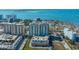 Captivating aerial view of high-rise condo featuring a rooftop pool and serene waterfront setting with city skyline backdrop at 800 N Tamiami Trl # 1217, Sarasota, FL 34236