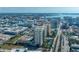 Aerial view of a multi-story building with a rooftop pool and stunning views of the surrounding city and waterway at 800 N Tamiami Trl # 1217, Sarasota, FL 34236