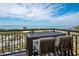 Relax on the balcony with seating and spectacular views of the ocean and blue skies at 800 N Tamiami Trl # 1217, Sarasota, FL 34236