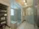 Modern bathroom showcasing a glass-enclosed shower, open shelving, and stylish finishes at 800 N Tamiami Trl # 1217, Sarasota, FL 34236