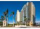 Luxury high-rise condominium building with multiple balconies and lush landscaping, offering an upscale living experience at 800 N Tamiami Trl # 1217, Sarasota, FL 34236