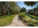 Inviting community path surrounded by tropical plants, offering a scenic route for leisurely strolls and connecting residents to nature at 800 N Tamiami Trl # 1217, Sarasota, FL 34236