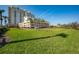 Expansive green lawn in front of condo, offering a large open space and enhancing the building's curb appeal at 800 N Tamiami Trl # 1217, Sarasota, FL 34236