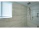 Walk in shower features a rain shower head and tiled walls at 800 N Tamiami Trl # 1217, Sarasota, FL 34236