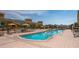 Resort-style swimming pool with lounge chairs and umbrellas on a sunny day at 800 N Tamiami Trl # 1217, Sarasota, FL 34236