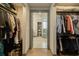 Spacious walk-in closet with organized storage, leading to an ensuite bath at 800 N Tamiami Trl # 1217, Sarasota, FL 34236