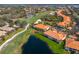 Aerial view of a golf course community with condos, a pond and manicured green spaces at 8414 Wethersfield Run # 102, Lakewood Ranch, FL 34202