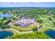 Aerial view of an elegant clubhouse, golf course, ponds and manicured landscaping at 8414 Wethersfield Run # 102, Lakewood Ranch, FL 34202