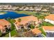 Beautiful yellow condos with terra cotta roofs overlook a pond, golf course and neighborhood at 8414 Wethersfield Run # 102, Lakewood Ranch, FL 34202