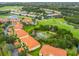 Aerial view of condos overlooking a golf course, lakes and manicured landscaping at 8414 Wethersfield Run # 102, Lakewood Ranch, FL 34202