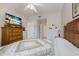 Comfortable bedroom features a ceiling fan and a flat screen television on a dresser at 8414 Wethersfield Run # 102, Lakewood Ranch, FL 34202