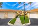 Exterior view of condo buildings with well-kept landscaping and assigned garages at 8414 Wethersfield Run # 102, Lakewood Ranch, FL 34202