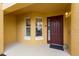 Charming entryway featuring a decorative front door, sidelight windows, and neutral exterior paint at 8414 Wethersfield Run # 102, Lakewood Ranch, FL 34202