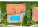 Aerial view of community pool with brick deck, lounge chairs and tropical landscaping at 8414 Wethersfield Run # 102, Lakewood Ranch, FL 34202