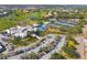 Aerial view of the Plantation Golf & Country Club featuring tennis courts and a golf course at 905 Barclay Ct, Venice, FL 34293