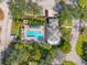 Aerial view of a single-Gathering home with an in-ground pool, mature trees, and a fenced yard at 905 Barclay Ct, Venice, FL 34293