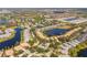 Aerial view of a community featuring houses nestled around scenic lakes and lush greenery at 905 Barclay Ct, Venice, FL 34293