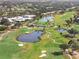 Scenic aerial view of the golf course with lush landscaping, ponds, and mature trees at 905 Barclay Ct, Venice, FL 34293